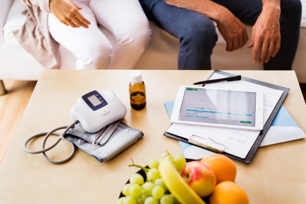 Home health caregiver using a tablet to document a visit in the field