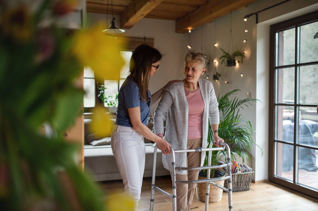 Healthcare worker or caregiver visiting a senior woman indoors at home
